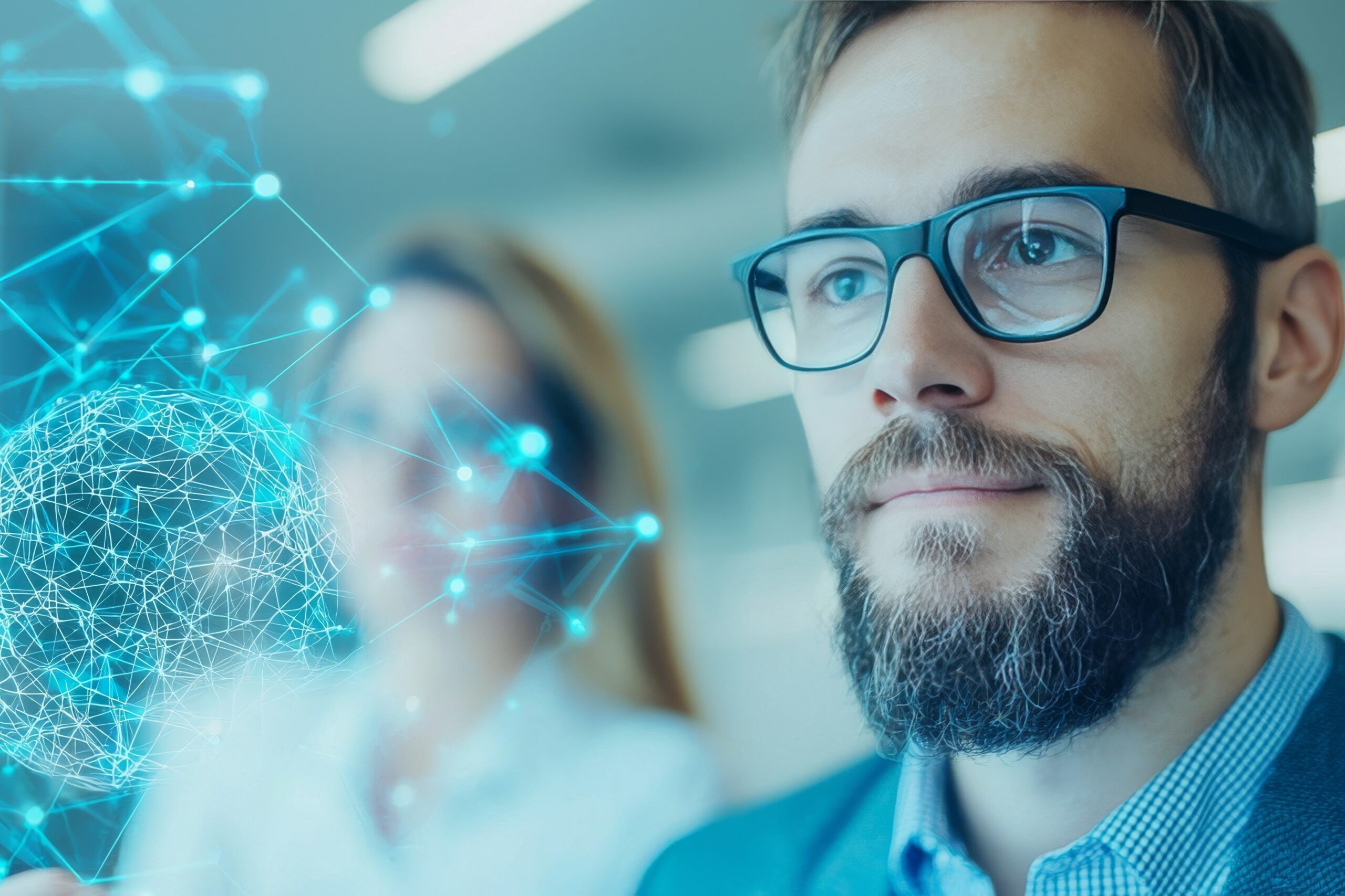 Man with beard and glasses looks thoughtfully at a digital globe. 11